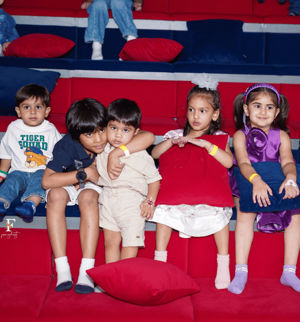 Children enjoying a fun movie experience together at Wooray Delhi, seated comfortably in a colorful indoor viewing area.