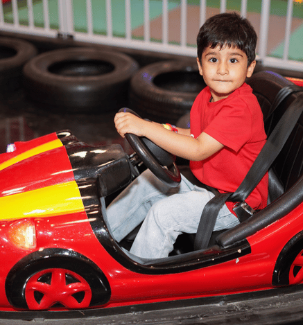 Child enjoying a fun bumper car ride at Wooray Delhi.