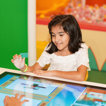 Child enjoying an Arcade Games  at Wooray Delhi indoor play area.